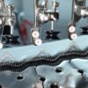 Macro view of knitting needles, sinkers, and smooth yarn threading mechanism on open width circular machine