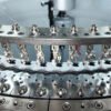 Precision yarn carriers and ceramic thread guides on 24G single jersey circular knitting machine cylinder
